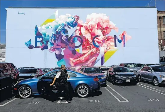  ?? Gary Coronado Los Angeles Times ?? HUEMAN’S “Bloom” mural on the Neptune Building in the Arts District honors the unofficial mayor of the area, the late urban pioneer, actor and activist Joel Bloom.