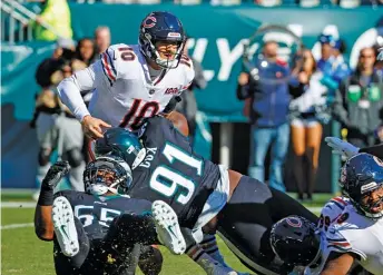  ?? AP ?? Bears quarterbac­k Mitch Trubisky takes a hit from Eagles defensive tackle Fletcher Cox on Sunday.