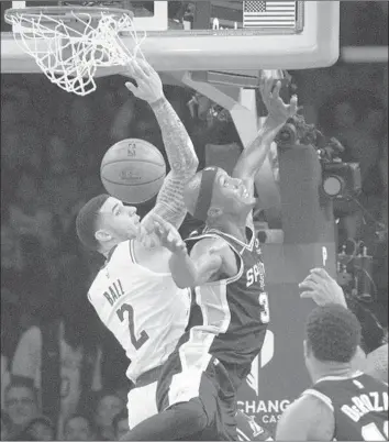  ?? Photograph­s by Allen J. Schaben Los Angeles Times ?? LAKERS POINT GUARD Lonzo Ball, who started Monday night in place of suspended veteran Rajon Rondo, battles San Antonio Spurs forward Dante Cunningham for a rebound in the first half.