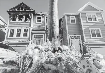  ?? DARREN CALABRESE THE CANADIAN PRESS ?? A memorial of flowers and stuffed toys is piled outside the scene of a fatal house fire in the Spryfield community of Halifax on Wednesday. Tuesday’s fire claimed the lives of seven children. Their parents, Syrian refugees who came to Canada in 2017, remain in hospital.