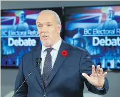  ?? GERRY KAHRMANN/PNG ?? Premier John Horgan speaks to Liberal Leader Andrew Wilkinson in a sometimes loud televised debate on electoral reform Thursday night.