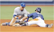  ??  ?? Blue Jays shortstop Richard Urena tags out Tampa Bay Rays’ Mallex Smith at second base during the seventh inning in St. Petersburg, Florida. Smith hit an RBI-single and was thrown out by left fielder Teoscar Hernandez as he tried for the extra base.