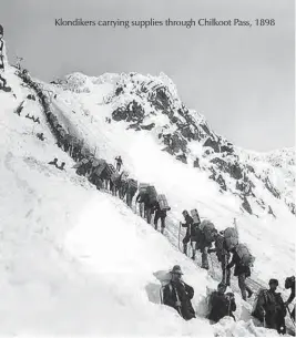  ??  ?? Klondikers carrying supplies through Chilkoot Pass, 1898