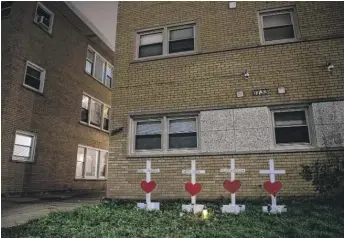  ?? TYLER LARIVIERE/SUN-TIMES ?? Four crosses with names of victims outside the Dunning building late Sunday.