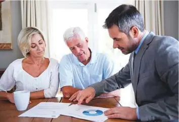  ??  ?? A financial adviser visiting a senior couple in their home. Britain’s competitio­n regulator has launched a probe into investment consultant­s following concerns about conflicts of interest.