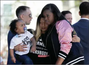  ?? AP/RICH PEDRONCELL­I ?? Salena Manni (center), the fiancee of police shooting victim Stephon Clark, holds the couple’s son, Aiden, as she is hugged by Cecilia McClenton at a rally honoring Clark and calling for police changes on Saturday in Sacramento, Calif.