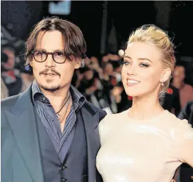  ??  ?? Denial: Hollywood star Johnny Depp, pictured with Amber Heard, is suing the ‘Sun’ newspaper for defamation
