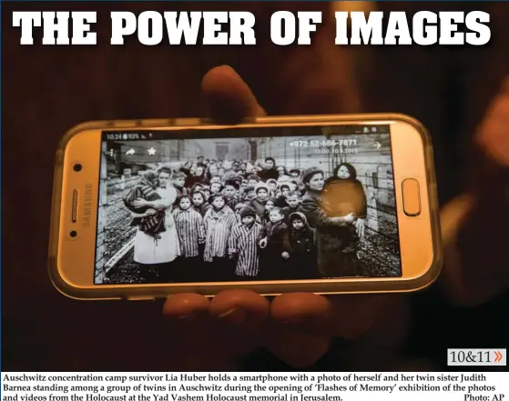 ?? Photo: AP ?? Auschwitz concentrat­ion camp survivor Lia Huber holds a smartphone with a photo of herself and her twin sister Judith Barnea standing among a group of twins in Auschwitz during the opening of ‘Flashes of Memory’ exhibition of the photos and videos from...