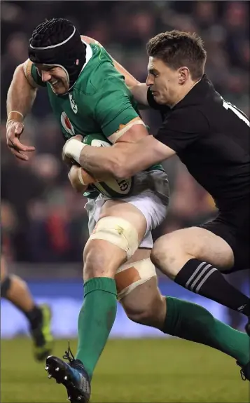  ??  ?? Ireland’s Seán O’Brien tries to shake off the attentions of Beauden Barrett of New Zealand.