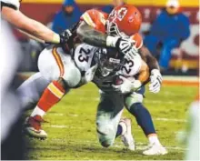  ??  ?? Broncos running back Devontae Booker gets hit hard by Kansas City Chiefs defensive tackle Rakeem Nunez-Roches after a short gain Sunday night. John Leyba, The Denver Post