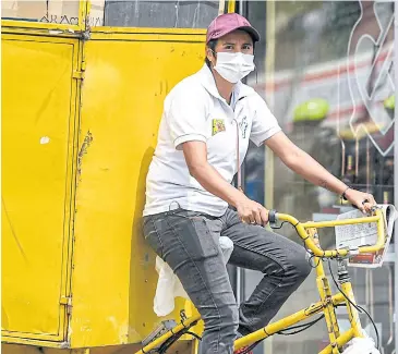  ?? AFP ?? A man uses a face mask as a precaution­ary measure against the spread of Covid-19 in Bogota on Wednesday.