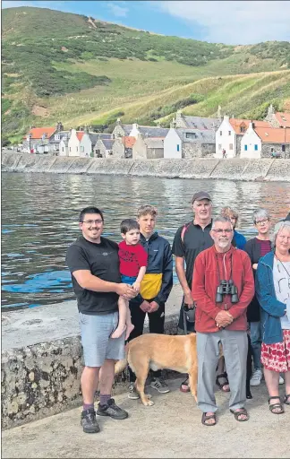  ??  ?? Crovie residents gather last week as frustratio­n grows over the closure of the sole road leading into the picturesqu­e seaboard community