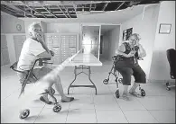  ?? AP/CARLOS GIUSTI ?? Manuela Libran, 67, and Maria Roman sit Wednesday under a damaged ceiling in a residence for low-income elderly people in Trujillo Alto, Puerto Rico.