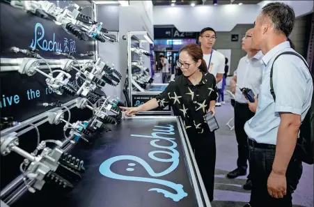  ?? ZHU JIPENG / FOR CHINA DAILY ?? Visitors check out flexible grips during the World Internet of Things Expo in Wuxi, Jiangsu province, in September 2019.