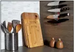  ?? For The Washington Post/STACY ZARIN GOLDBERG ?? New accessorie­s can freshen a kitchen. Natural wood cutting boards leaning against a backsplash visually warm up and soften the space.