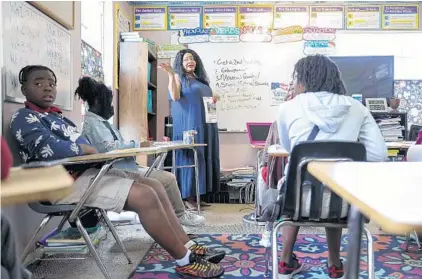  ?? ARIELLE BADER/TAMPA BAY TIMES ?? Local Realtor Kella McCaskill teaches a lesson on real estate framed in the context of the housing market changes to students at LinaBean Academy March 23 in Tampa.