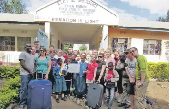  ??  ?? Volunteers present donations to Fuka School and Orphanage.