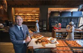  ?? STEVE RINGMAN, THE SEATTLE TIMES ?? Starbucks executive chair Howard Schultz shows off the new Princi shop at the Starbucks Roastery on Capitol Hill in Seattle.