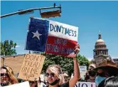  ?? Sergio Flores / Getty Images ?? Protesters march outside the Texas Capitol last month in response to Gov. Greg Abbott’s signing of a law that outlaws abortions after a fetal heartbeat is detected, about six weeks into pregnancy.