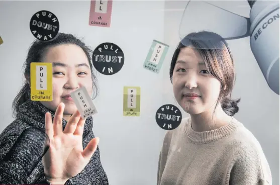  ?? Photo / Michael Craig ?? Tina Kim (left) and Sarah Lee are launching a “Happy Pull” campaign using positive messages in a bid to bring down New Zealand’s high suicide rates.