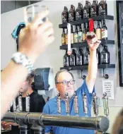  ?? [PHOTO BY NATE BILLINGS, THE OKLAHOMAN] ?? Co-owner Alan Musser raises a glass to Senate Bill 424 with others at 4:24 P.M. Friday at Anthem Brewing Co., 908 SW 4 in Oklahoma City. Senate Bill 424 went into effect on Friday.