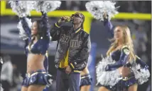  ?? Associated Press file photo ?? In this Jan. 6 file photo, Snoop Dogg performs with the Los Angeles Rams cheerleade­rs during halftime of an NFL football wild-card playoff game against the Atlanta Falcons in Los Angeles.