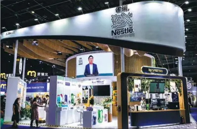  ?? PROVIDED TO CHINA DAILY ?? Visitors check out Nestle products during the fifth China Internatio­nal Import Expo in Shanghai in November.