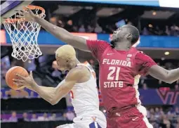  ?? CHUCK BURTON/AP ?? Florida State’s Christ Koumadje, right, said he is determined to stay out of foul trouble during the NCAA Tournament.