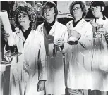  ?? GETTY IMAGES ?? A television still shows the popular music and television group the Monkees dressed as ‘‘mad scientists,’’ complete with bubbling beakers, lab coats, and glasses, early 1970s. They are, from left, Davy Jones, Peter Tork, Mickey Dolenz and Michael Nesmith.