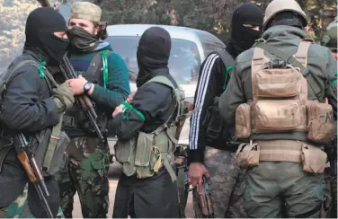  ?? Ibaa News Agency ?? Al Qaeda-linked fighters from the Levant Liberation Committee prepare for battle in Idlib province, Syria.