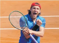  ?? AFP ?? France’s Lucas Pouille gestures to his teammates after beating Italy’s Fabio Fognini.