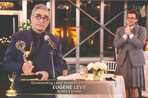  ?? PHOTO BY IMAGE GROUP LA / AMERICAN BROADCASTI­NG COMPANIES, INC. /ABC/AFP ?? Canadian actor Eugene Levy speaks after receiving his Emmy while his son, actor/director/writer Daniel Levy, watches during the 72nd Primetime Emmy Awards ceremony held virtually on Sunday. Daniel Levy took home three Emmys himself shortly after his dad's speech.