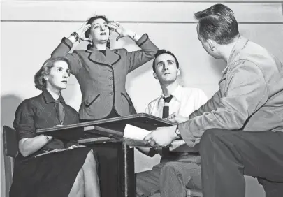  ?? THE COMMERCIAL APPEAL FILES ?? Director Tom Fitzsimmon­s, right, puts finishing touches on a seance scene from noel Coward’s “Blithe Spirit,” which has a week’s run in January 1952 at the new Arena Theatre playhouse in the basement of the King Cotton Hotel. Rosemary Murphy, medium Carolyn Brenner and Rex Partington get rather more than they bargained for from the spirit world.