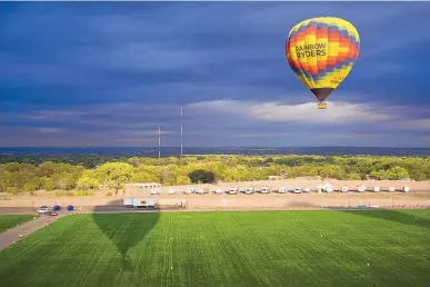  ?? MARLA BROSE/JOURNAL ?? A Rainbow Ryders’ hot air balloon returns to Balloon Fiesta Park after a flight that launched from the field in 2017.