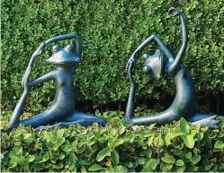  ??  ?? Yoga frogs from frontgate.com will bring smiles and maybe inspiratio­n posing in your garden.