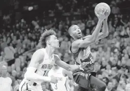  ?? MATT YORK/AP ?? Mikal Bridges drives past Jaxson Hayes during the Suns’ 112-97 victory over the Pelicans on Tuesday in Game 5 of their Western Conference first-round playoff series.