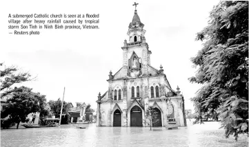  ??  ?? A submerged Catholic church is seen at a flooded village after heavy rainfall caused by tropical storm Son Tinh in Ninh Binh province, Vietnam. — Reuters photo