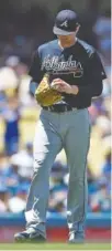  ?? THE ASSOCIATED PRESS ?? Atlanta starting pitcher Sean Newcomb reacts after being unable to make a play on an infield grounder during the third inning of Sunday’s game against the Dodgers in Los Angeles.