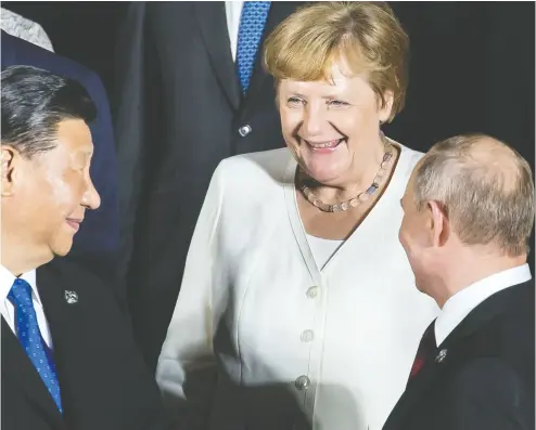  ?? TOMOHIRO OHSUMI / AFP via Gett
y Imag
es files ?? Germany’s Chancellor Angela Merkel is the closest thing Europe has to a strong figure, while China’s President Xi Jinping, left, and Russia’s President Vladimir Putin right, are expanding their empires, Kelly Mcparland writes.