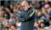 ??  ?? Manchester City manager Pep Guardiola looks stunned during the 4-0 loss to Everton on Monday.