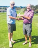  ??  ?? Allan Thomson presenting Owen Howl his Hole in One trophy.