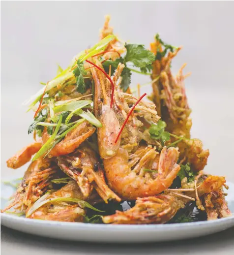  ?? DARREN CHEUNG ?? Angus An's Black-Pepper Spot Prawns are deep-fried in a light batter then stir-fried in an aromatic paste of garlic, chilies and cilantro root. Pair with a glass of 2018 Gray Monk Odyssey White Brut Méthode Classique.