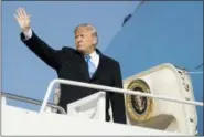  ?? ANDREW HARNIK — THE ASSOCIATED PRESS ?? President Donald Trump waves as he boards Air Force One at Andrews Air Force Base, Md., Tuesday to travel to Pittsburgh following last weekends shooting at Tree of Life Synagogue.
