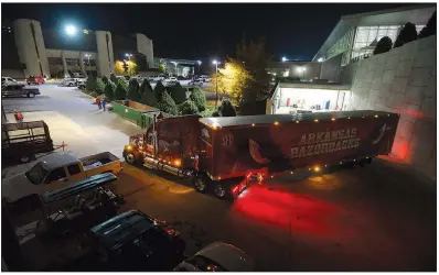  ?? NWA Democrat-Gazette/ANDY SHUPE ?? with Arkansas Razorbacks football gear pulls away Thursday from the Fred Smith Football Center in Fayettevil­le, headed to Baton Rouge for today’s game.