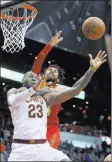  ?? John Bazemore ?? The Associated Press Hawks forward Deandre Bembry, rear, fouls Cavaliers forward Lebron James in the second half of Cleveland’s 121-114 victory Thursday at Philips Arena.