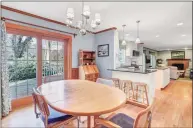  ??  ?? This butcher block table in the eating area of the kitchen is located next to French doors to the back deck and holds many memories.