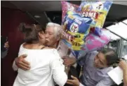  ?? RICHARD DREW — ASSOCIATED PRESS ?? Luis Mendez Chanes, center, is reunited with his daughter Marta Mendez who he hasn’t seen in 24-years, and her husband Luis Flores, from Queens, as they ride the Bateaux New York boat.