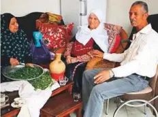  ?? AFP ?? Palestinia­n refugee Khadija Sharkawi (centre), 85, with her family members at her home in the Amari refugee camp near the West Bank city of Ramallah yesterday.