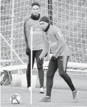  ?? FRANCK FIFE/GETTY-AFP ?? Paris Saint-Germain forward Kylian Mbappe, right, takes part in a training session last week at the team’s Camp des Loges training grounds west of Paris.