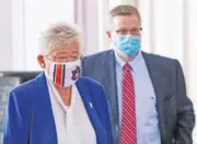  ?? MICKEY WELSH/THE MONTGOMERY ADVERTISER VIA AP ?? Alabama Gov. Kay Ivey and State Health Officer Dr. Scott Harris arrive to announce a statewide mask order during a news conference Wednesday in the state capitol building in Montgomery, Ala.